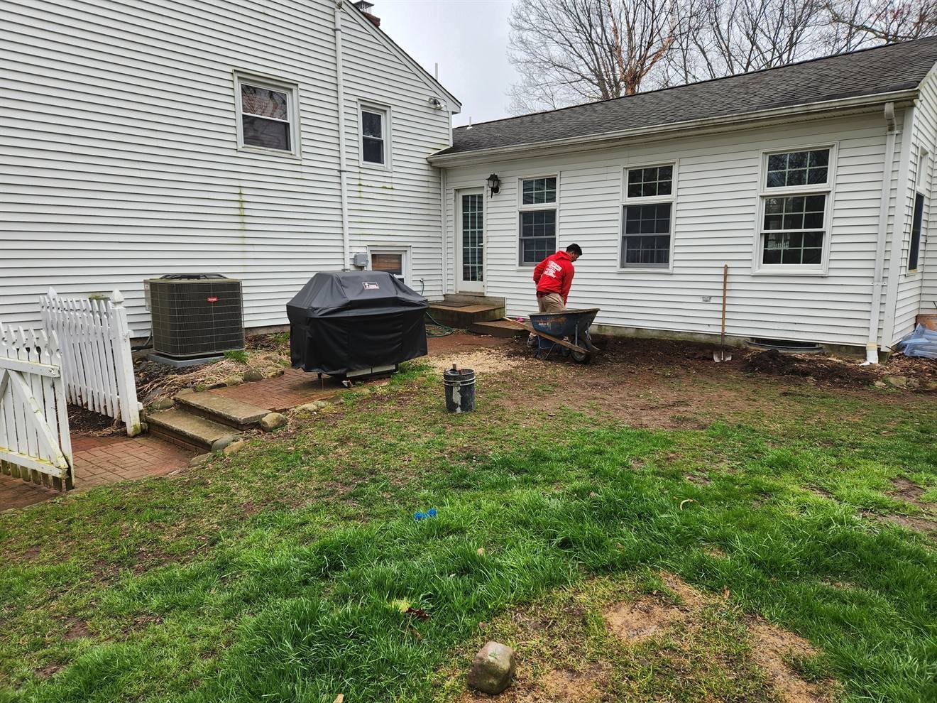Rear yard before installation of a curved paver patio