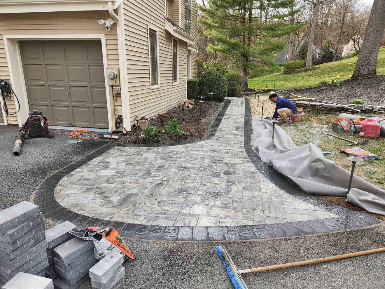 Curved paver patio during perimeter and surface installation