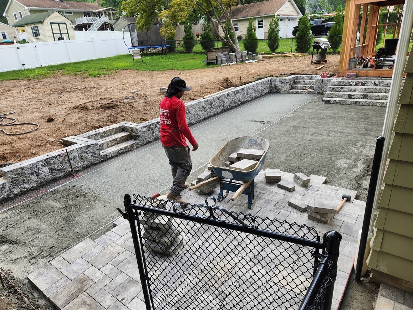 Raised backyard patio and seating wall during construction