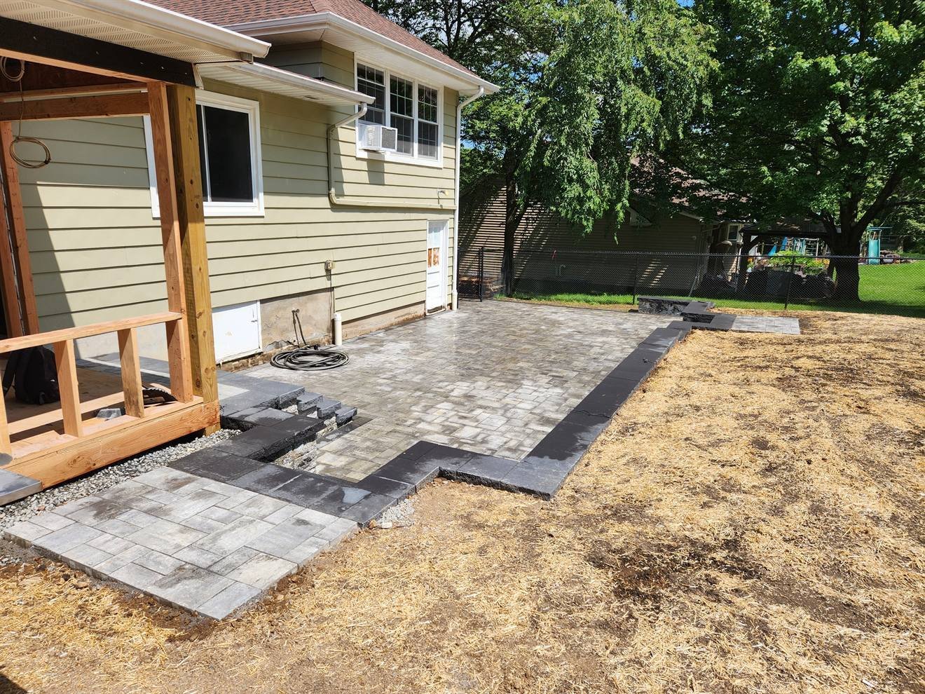 Paver terrace with dark border and connected steps