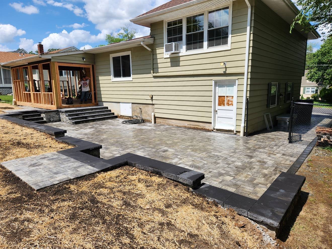 Wide view of the raised paver patio and retaining edge