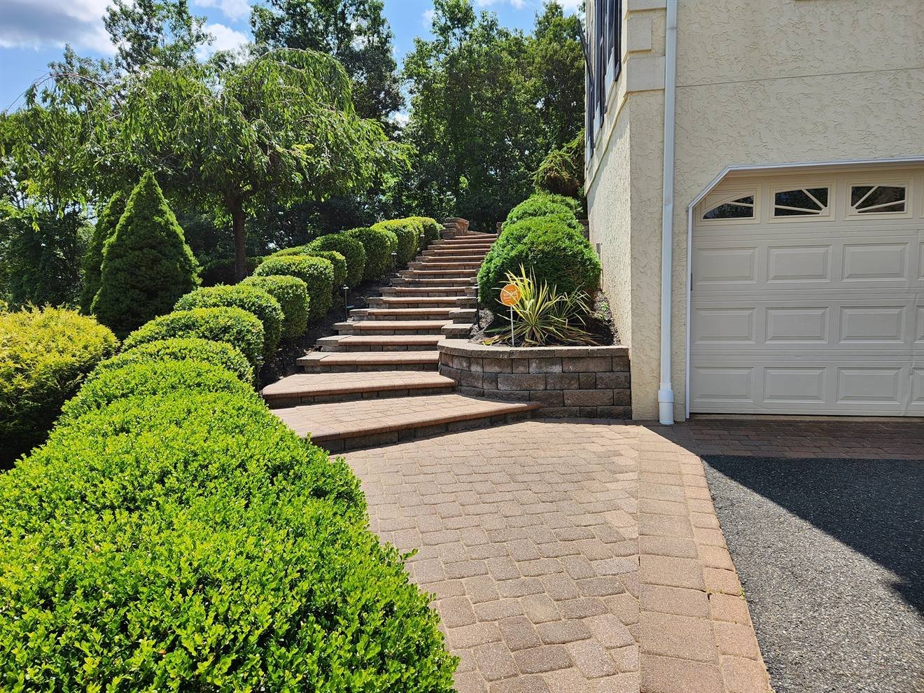Paver driveway approach leading toward masonry steps