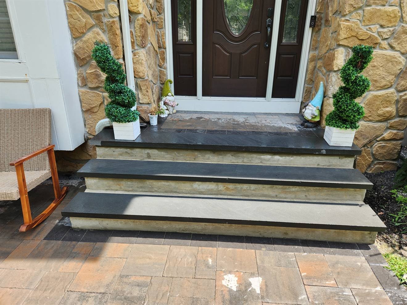 Front entrance steps finished with contrasting stone treads