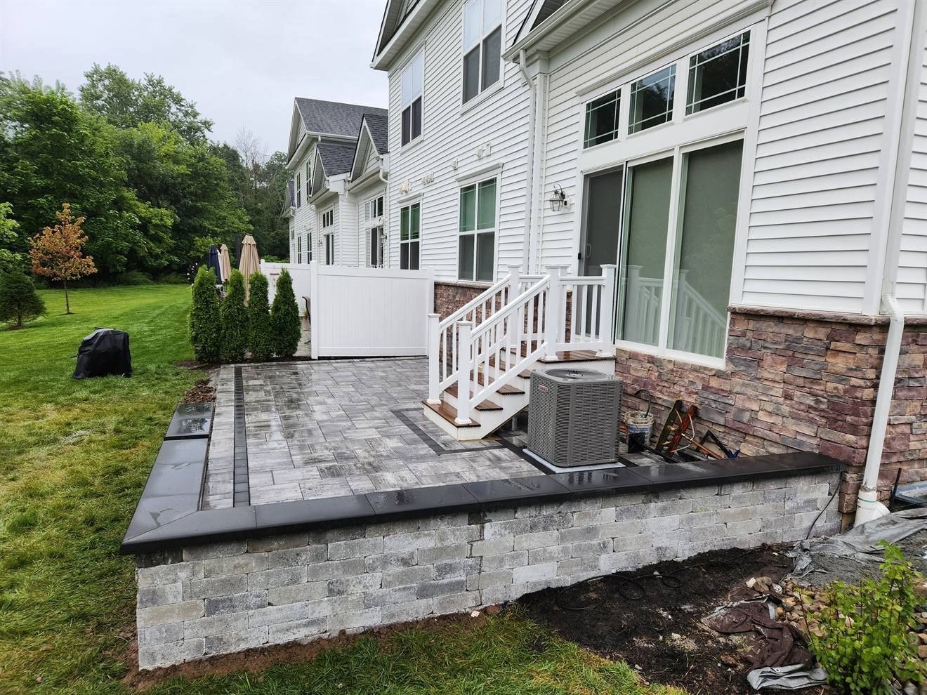 Wide view of the patio, steps, and retaining edge
