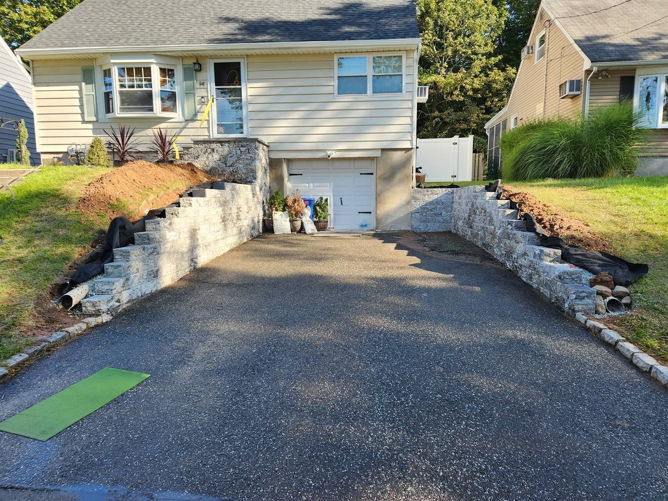 Completed driveway edge supported by a block retaining wall