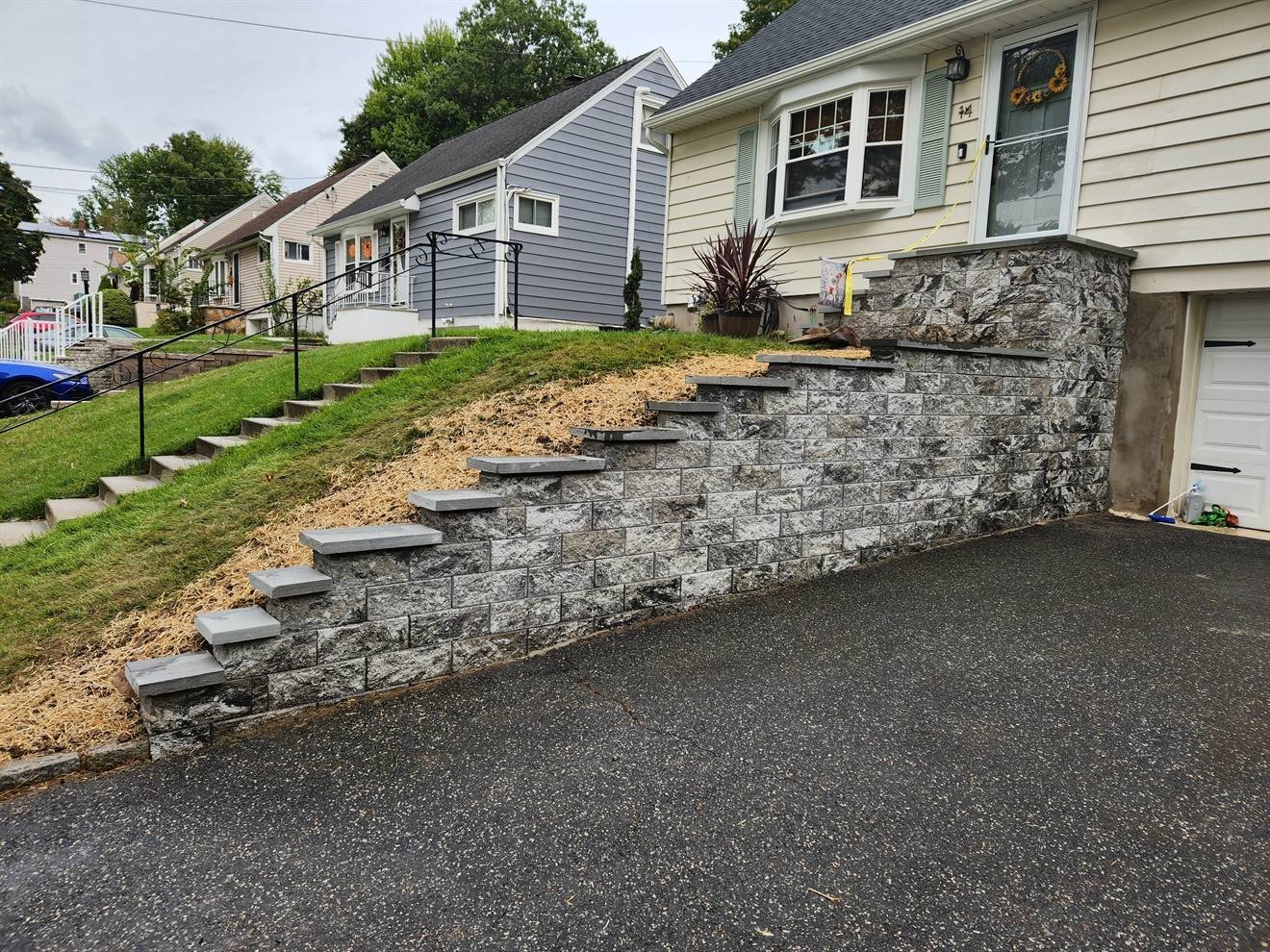 Finished retaining wall and steps following the driveway grade