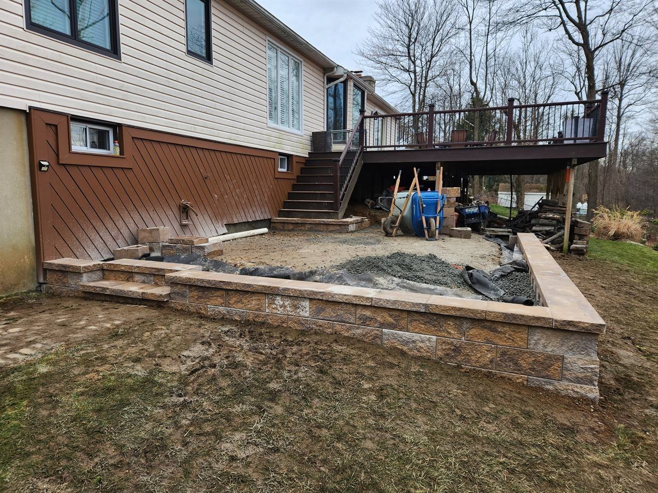 Raised patio area during base preparation below a deck