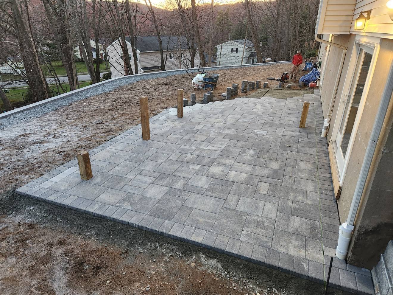 Wide construction view of the paver patio and perimeter