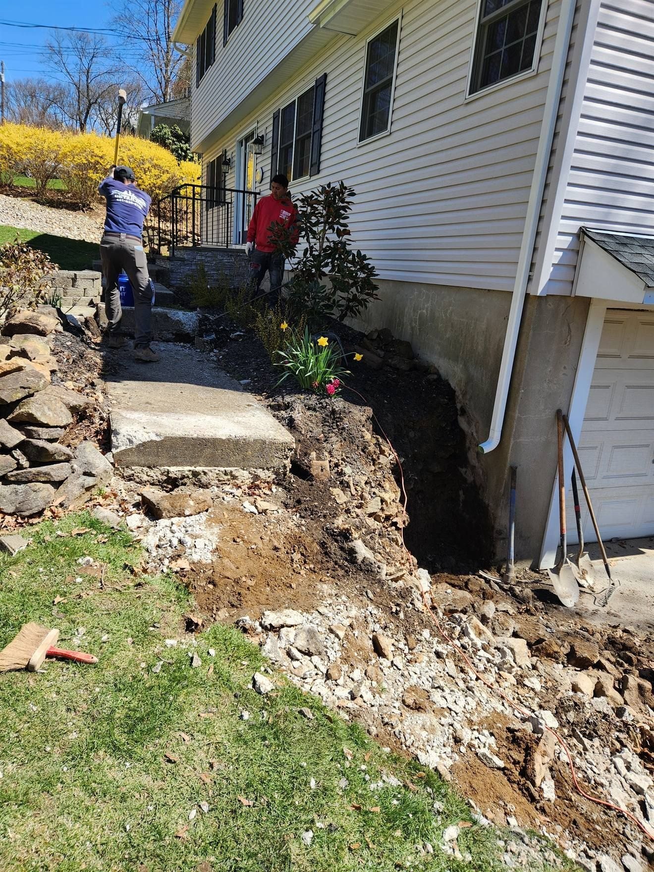Excavated side yard during retaining-wall preparation