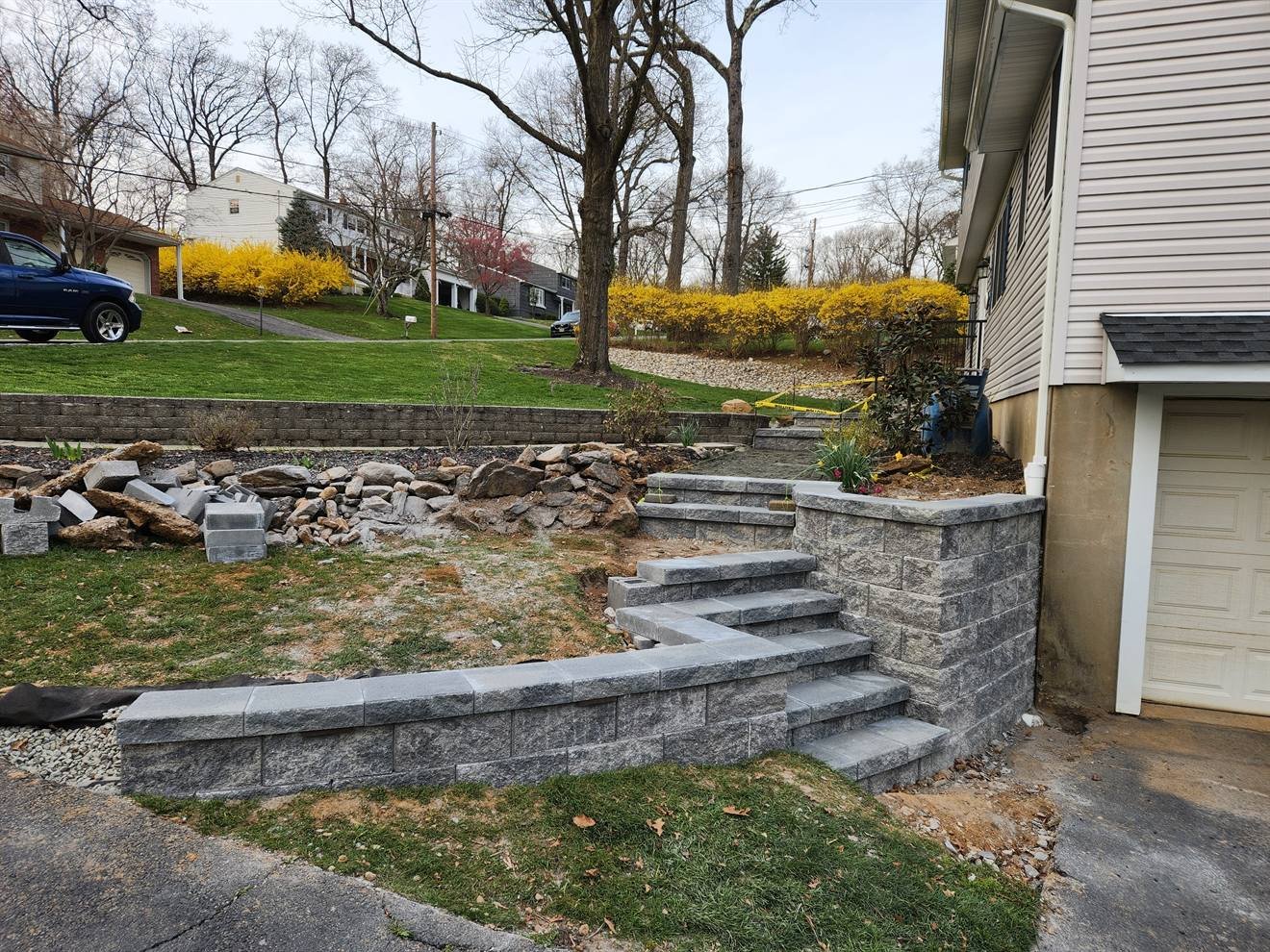 Multi-level retaining wall and steps beside the home