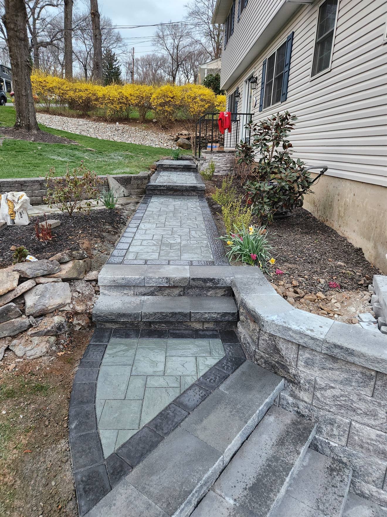 Paver walkway connecting the new steps and wall