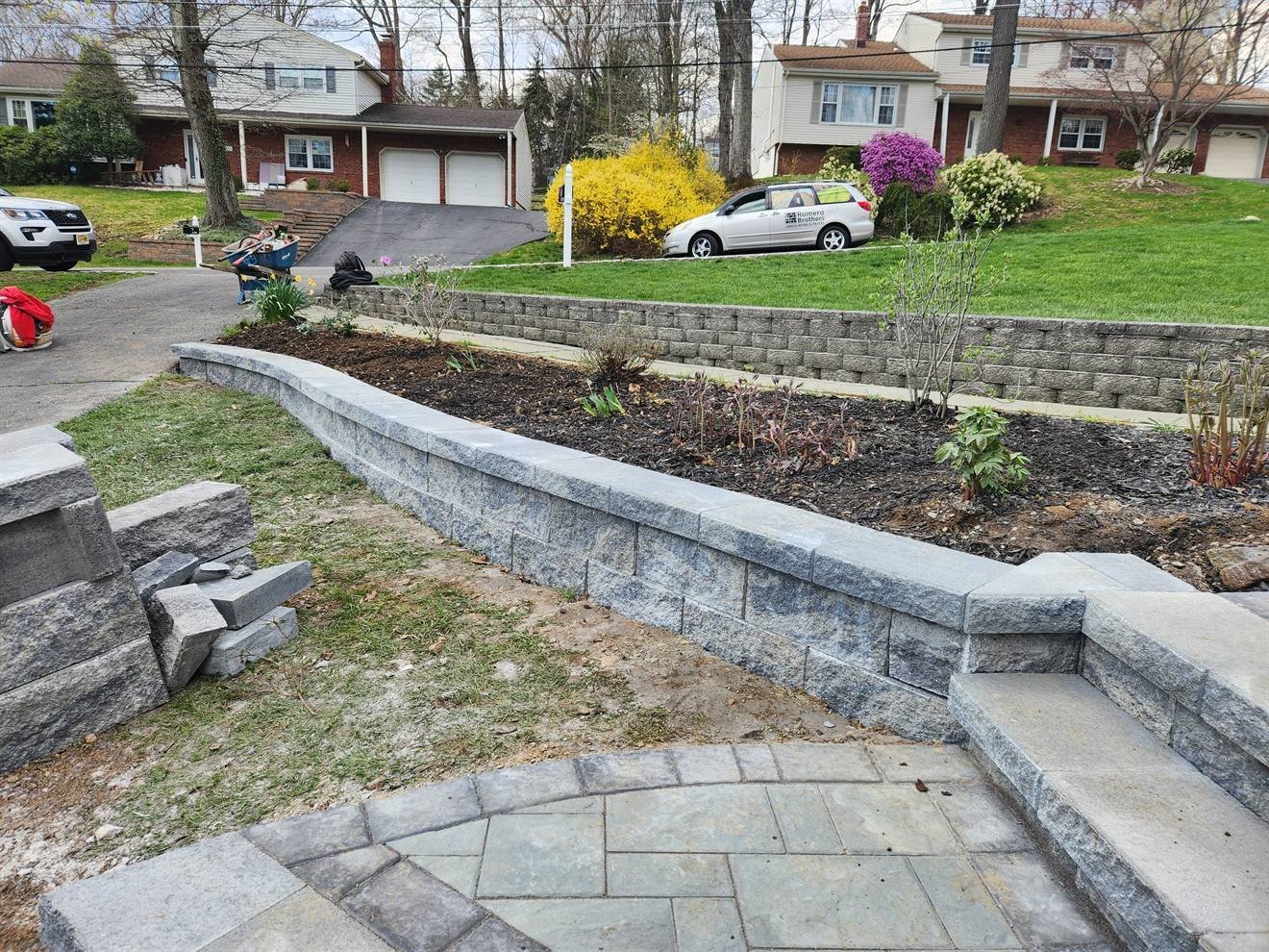Completed retaining wall, steps, walkway, and planting beds