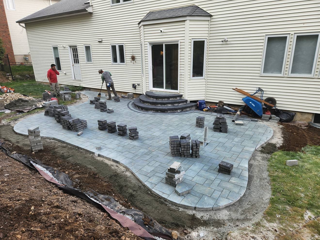 Curved paver patio during surface installation