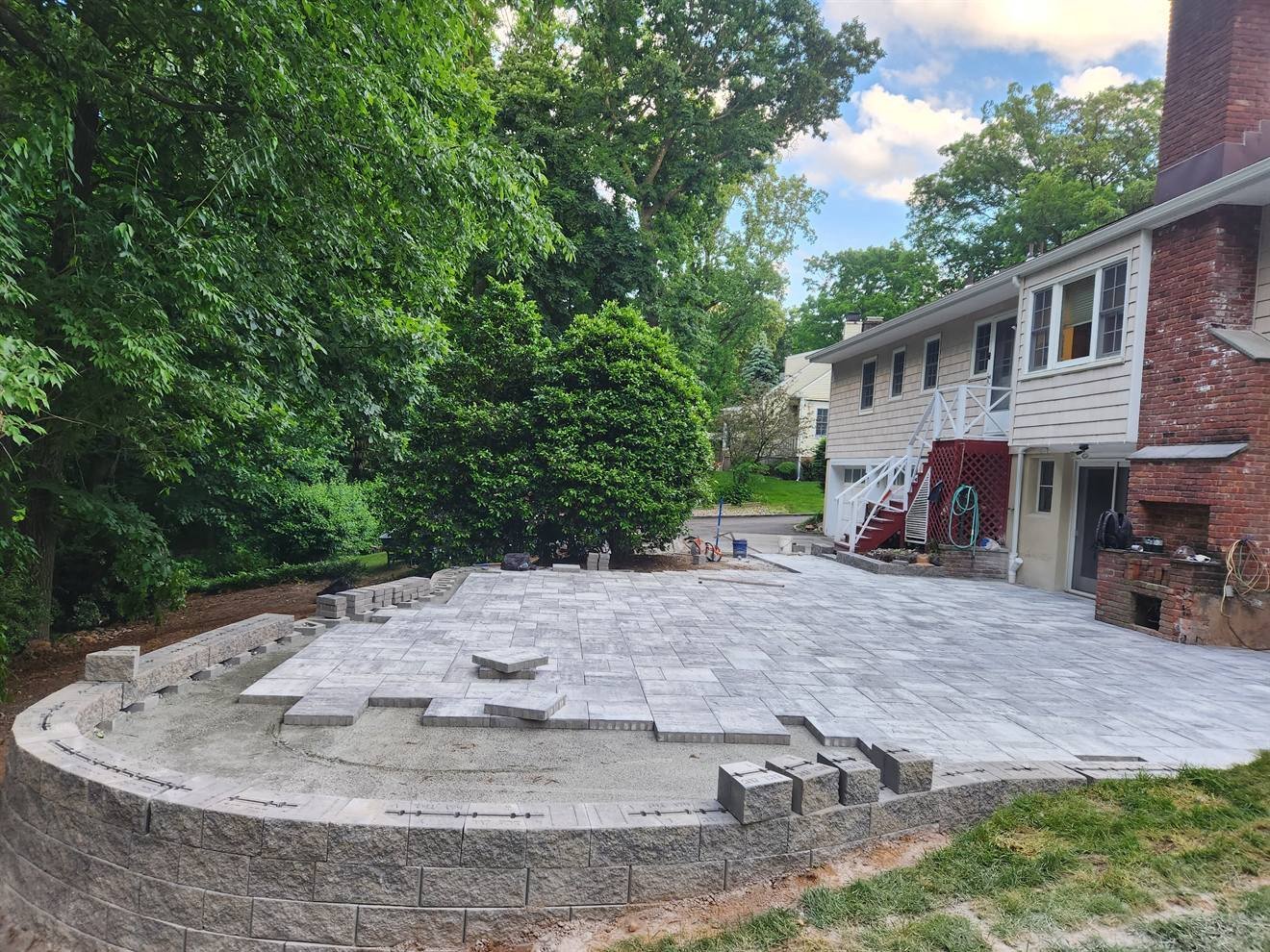 Large completed paver surface with curved seating wall