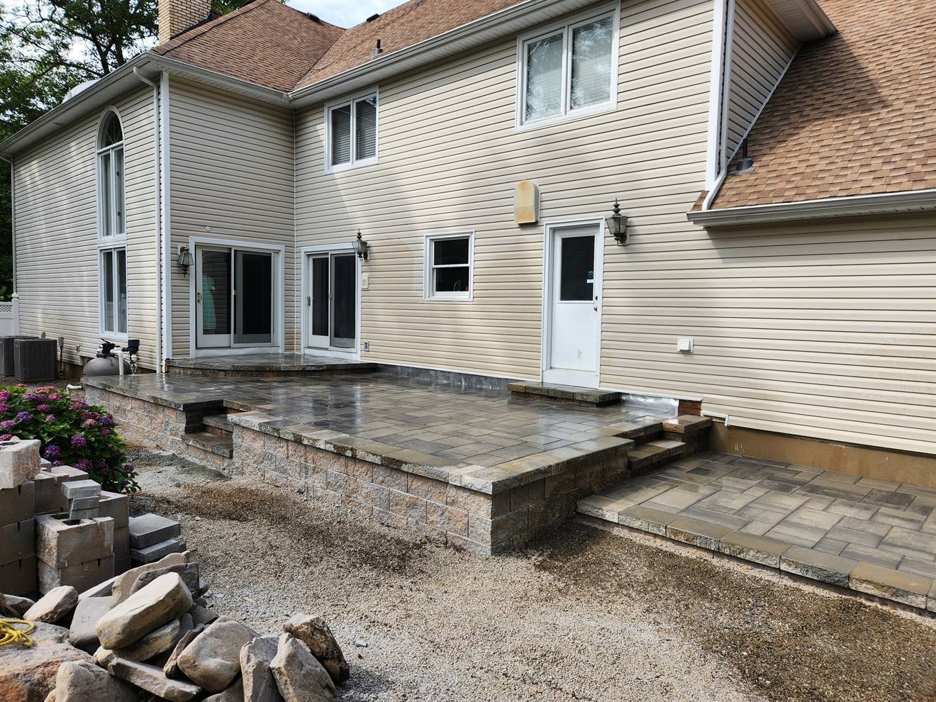 Paver patio levels and masonry steps nearing completion